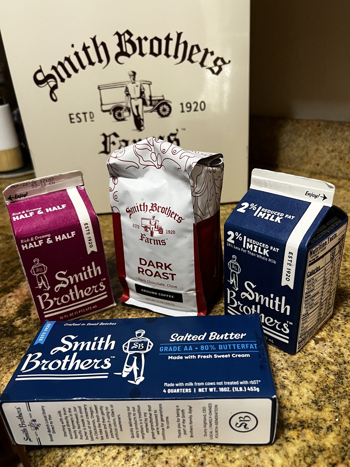 Smith Brothers milk, half and half, butter, and dark roast coffee in front of the insulated delivery box
